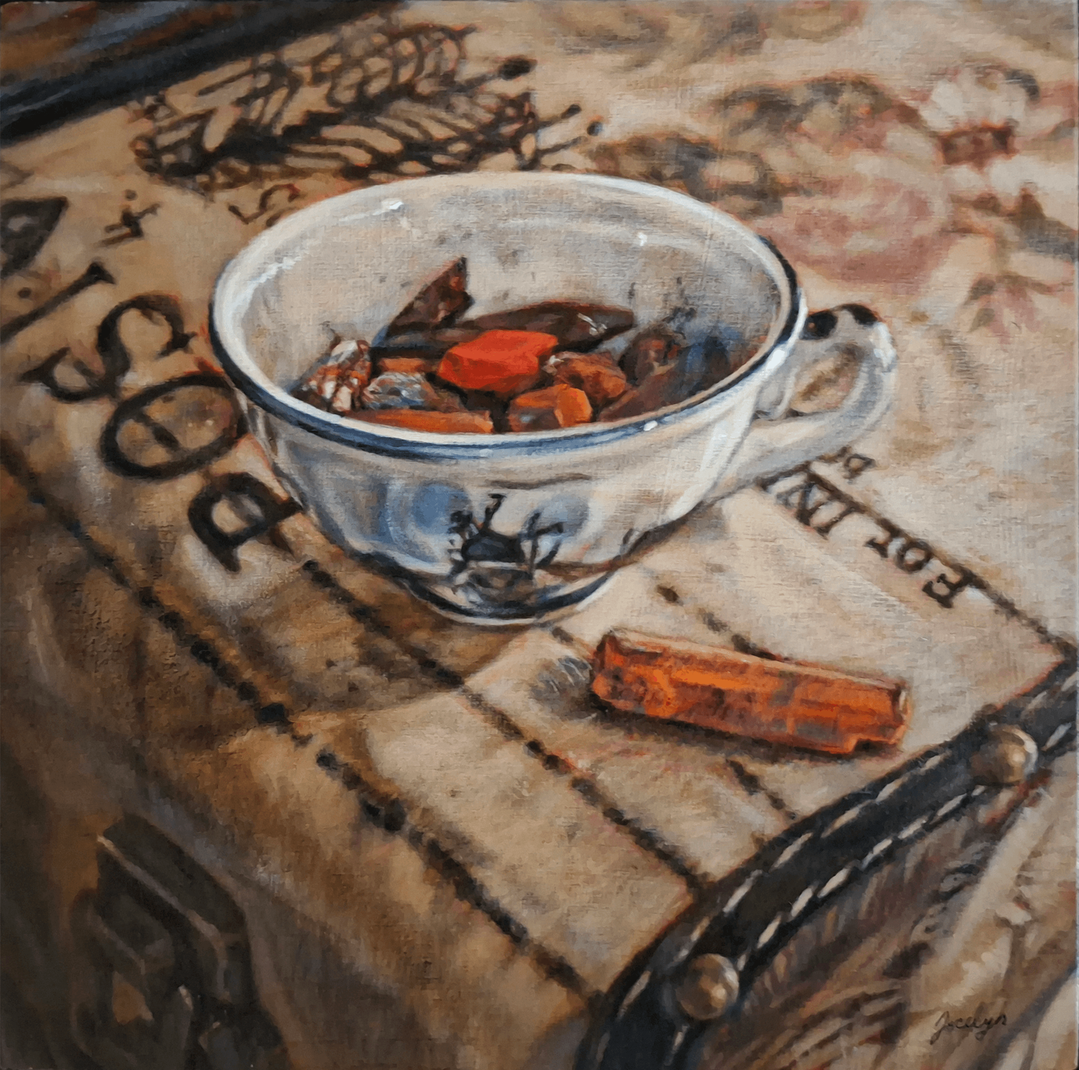 teacup filled with pastels on vintage suitcase