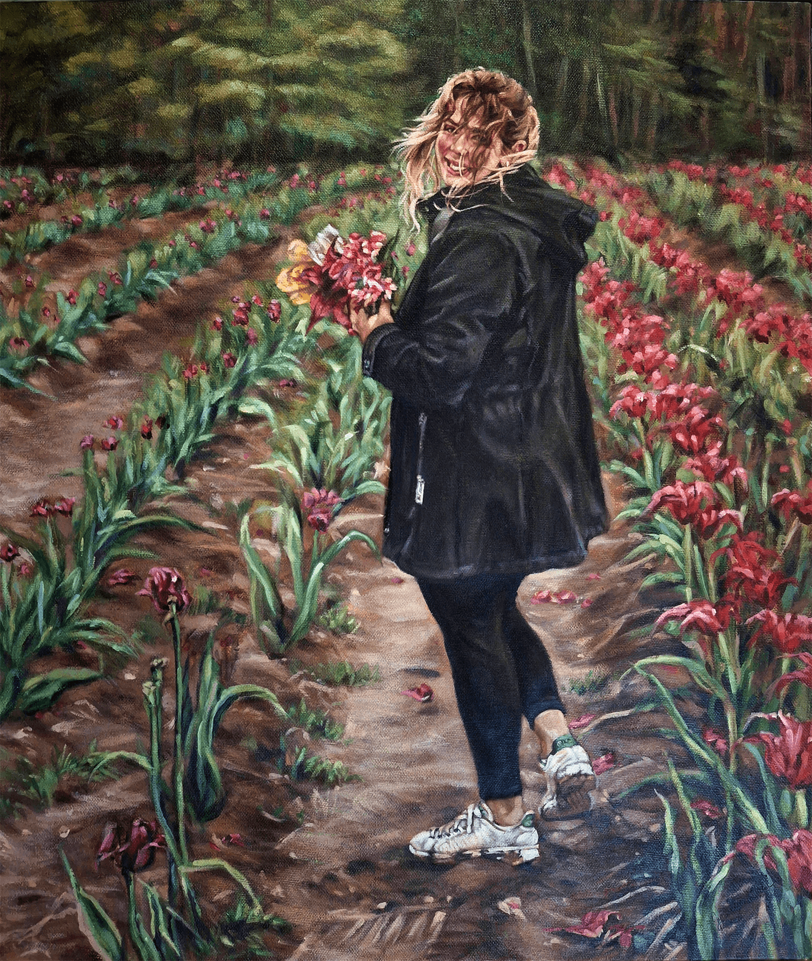 young woman holding bouquet of flowers in a tulip field